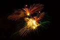 Double orange and green fireworks display in night sky Royalty Free Stock Photo