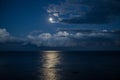 Night sky with full moon and reflection in sea. Royalty Free Stock Photo