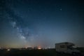 Night sky landscape in Orcia Valley, Tuscany, Italy. The Milky Way galaxy and stars over a camper van parked in the hill range