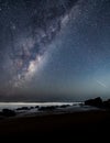 Milkyway seascape with rocks and shooting star