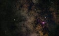 Night sky with milky way near Sagittarius constellation, bright Kaus Borealis star in lower middle, purple Lagoon and Trifid