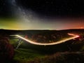 Night sky with milky way and stars, night road illuminated