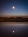 Night sky with Moon, Jupiter and Venus above the lake Royalty Free Stock Photo