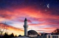 A moon in the pink clouds of the night. Mosque against the background of the sky Royalty Free Stock Photo