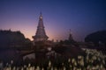 Night sky of moving Milky Way and stars under moon light at Phra Mahathat monuments on Doi Inthanon