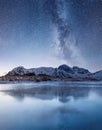 Night sky and reflection on the frozen lake. Royalty Free Stock Photo