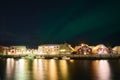 Night sky, Scandinavian houses and reflections, Aurora Borealis Northern lights Royalty Free Stock Photo