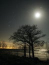 Night sky stars Pleiades Venus and Moon set observing over sea coast Royalty Free Stock Photo