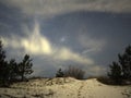 Night sky Lyra constellation stars clouds and snow observing winter landscape