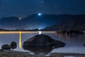 Night sky stars over mountain lake. Summer starry night