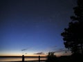 Night sky stars observing Perseus constellation over sea