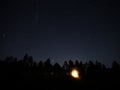 Night sky stars Pleiades and Moon rise over forest