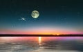 Blue bright starry sky on pink yellow sunset at sea water vawe reflection blurred light full moon moonlight  skyline  nebula natur Royalty Free Stock Photo