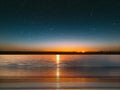 starry sky on pink yellow sunset at sea water vawe reflection blurred light full moon moonlight  skyline  nebula natur Royalty Free Stock Photo