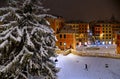 Night snowfall on empty Spanish square and steps in Rome with church Trinita di Monti in background, Italy. Piazza di Spagna