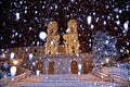 Night snowfall on empty Spanish square and steps in Rome with church Trinita di Monti in background, Italy. Piazza di Spagna