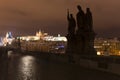 Night colorful snowy Christmas Prague Lesser Town with gothic Castle with Charles Bridge, Czech republic Royalty Free Stock Photo