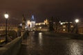 Night colorful snowy Christmas Prague Lesser Town with gothic Castle with Charles Bridge, Czech republic Royalty Free Stock Photo