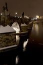 Night snowy colorful Prague Lesser Town with gothic Castle, St. Nicholas` Cathedral from Charles Bridge, Czech republic Royalty Free Stock Photo