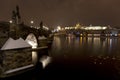 Night snowy colorful Prague Lesser Town with gothic Castle, St. Nicholas` Cathedral and Charles Bridge, Czech republic Royalty Free Stock Photo