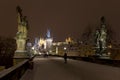 Night snowy colorful Prague Lesser Town with gothic Castle, St. Nicholas` Cathedral from Charles Bridge, Czech republic Royalty Free Stock Photo