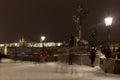 Night snowy colorful Prague Lesser Town with gothic Castle, St. Nicholas` Cathedral from Charles Bridge, Czech republic Royalty Free Stock Photo