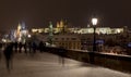 Night snowy colorful Prague Lesser Town with gothic Castle, St. Nicholas` Cathedral from Charles Bridge, Czech republic Royalty Free Stock Photo