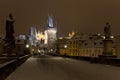 Night snowy colorful Prague Lesser Town with gothic Castle, St. Nicholas` Cathedral from Charles Bridge, Czech republic Royalty Free Stock Photo