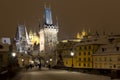 Night snowy colorful Prague Lesser Town with gothic Castle, St. Nicholas` Cathedral from Charles Bridge, Czech republic Royalty Free Stock Photo