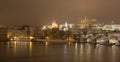 Night snowy Prague gothic Castle with Charles Bridge and St. Nicholas' Cathedral , Czech republic Royalty Free Stock Photo