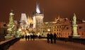 Night snowy Prague gothic Castle and St. Nicholas' Cathedral from Charles Bridge, Czech republic Royalty Free Stock Photo