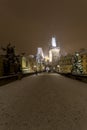 Night snowy Prague Lesser Town with Bridge Tower and St. Nicholas' Cathedral from Charles Bridge with its Statues Royalty Free Stock Photo