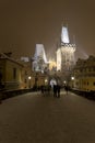 Night snowy Prague Lesser Town with Bridge Tower and St. Nicholas' Cathedral from Charles Bridge with its Statues Royalty Free Stock Photo