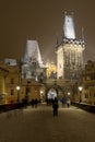 Night snowy Prague Lesser Town with Bridge Tower and St. Nicholas' Cathedral from Charles Bridge with its Statues, Royalty Free Stock Photo