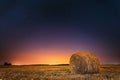 Night Starry Sky Above Field Meadow With Hay Bale After Harvest. Royalty Free Stock Photo