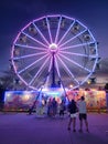 A night at the state fair. Carnival, state fair, ferris wheel,  rides, sunset, evening, entertainment, fun, Royalty Free Stock Photo