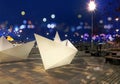 Night street art neon blurred light and modern installation white ship decoration people walk and relax in Tallinn Estonia