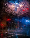 Night street through the car\'s window. Night lights under the rain