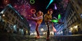 Night street circus performance whit two clowns, jugglerFestival city background. fireworks and Celebration atmosphere.Wide engle Royalty Free Stock Photo