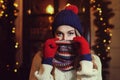 Night street portrait of young beautiful woman in classic stylish warm winter knitted clothes with scarf covering her Royalty Free Stock Photo