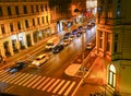 Night street scene from high point of view people, cars, pedestrian crossing in night lights from street and surrounding shops