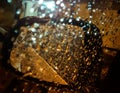Night street. Side view mirror of motor vehicle covered in raindrops. Royalty Free Stock Photo