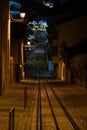 Night street with a steep slope and a tram or railway track leading to the end of an illuminated. Royalty Free Stock Photo