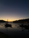 Night sunset scene in the shore of the Douro river with quiet sailing boats silhouettes in Porto skyline, Portugal Royalty Free Stock Photo