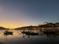 Night sunset scene in the shore of the Douro river with quiet sailing boats silhouettes in Porto skyline, Portugal Royalty Free Stock Photo