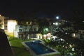 Night swimming pool for relaxation and rest in the garden during the summer season by the light of lanterns at home Royalty Free Stock Photo