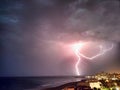 Night thunderstorm and lightning blots over the sea near the coast Royalty Free Stock Photo