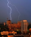Night thunderstorm over the city and lightning strikes in high-rise building Royalty Free Stock Photo