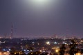 Night time city lights. Big city lighted with moon Royalty Free Stock Photo