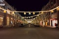 Night time, empty retail street with lights